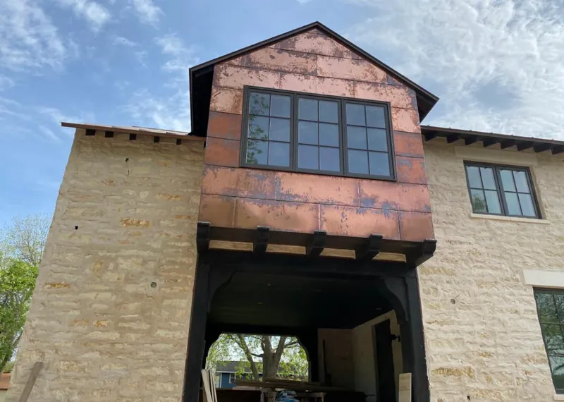 Copper metal panel facade on a stone building for Skylight Installation in Carbondale